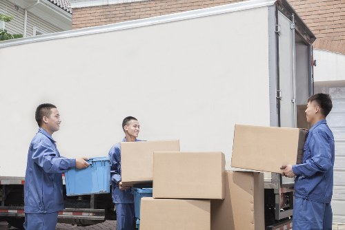 Trained removal staff handling furniture safely during a move