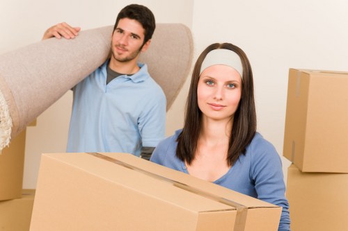 Professional movers carrying furniture at a Cannhall property